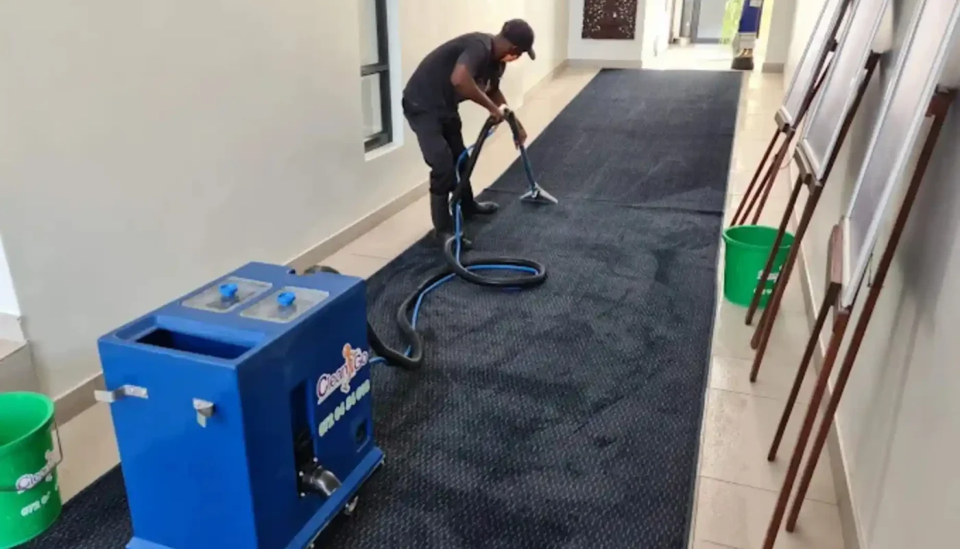 Professional carpet cleaner at work on a fitted carpet